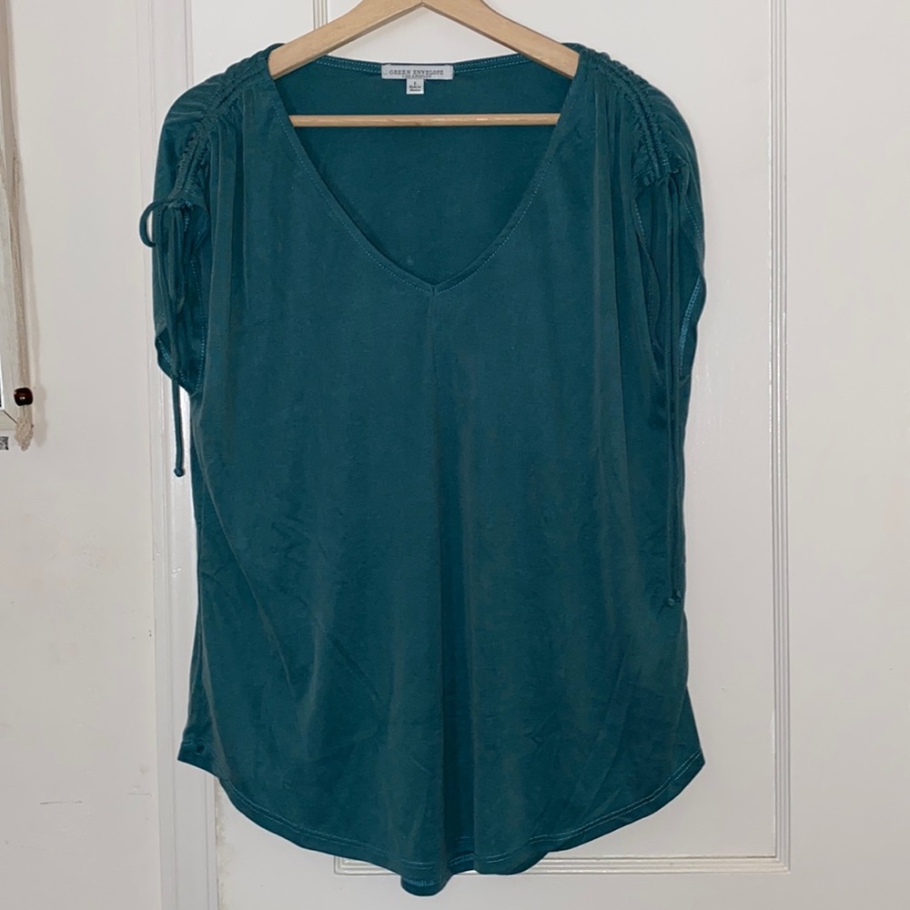 Blue T-shirt with ties on the arms. V neck. Worn once. Cute for summer.